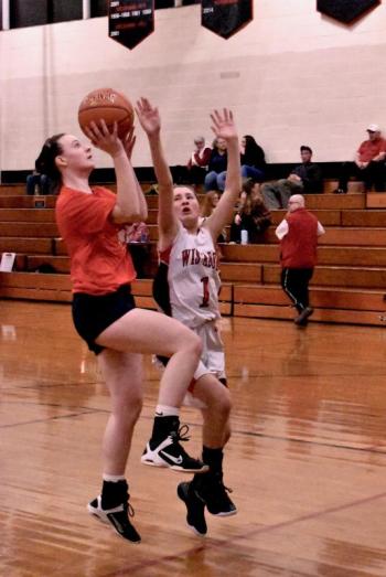 Grace Webber netted six points for the alumni in the final quarter. Defending is Brianna Orr. PHIL DI VECE/Wiscasset Newspaper