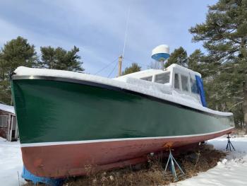 A boat keeps snow off part of a yard opposite Wiscasset Municipal Airport on Chewonki Neck Road Jan. 23. SUSAN JOHNS/Wiscasset Newspaper