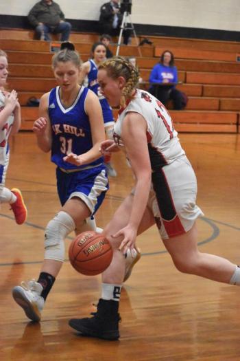 Madison Carrier played a good floor game for the Wolverines against Oak Hill. Also shown is Bri Dumais of the Raiders. PHIL DI VECE/Wiscasset Newspaper