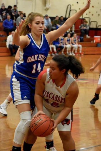 Latisha Wright is hemmed in by Oak Hill’s Peighton Theriault. PHIL DI VECE/Wiscasset Newspaper