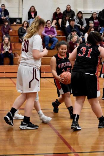 Latisha Wright (with the ball) and the Wolverines opened the tournament against the Mustangs. PHIL DI VECE/Wiscasset Newspaper