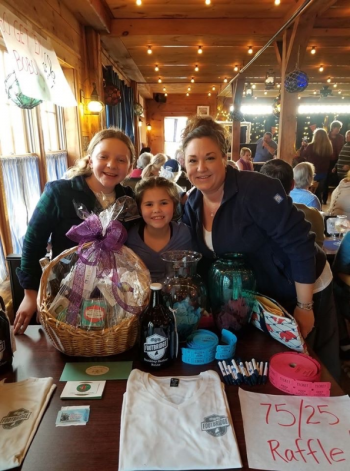 Suzie Edwards, Olivia Roberts and Kyndall Schmidt are all smiles at the raffle table. Courtesy of Jen Mitchell