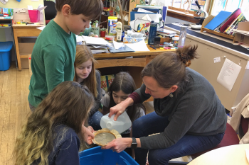 Marci Train, a teacher at Long Island School in Casco Bay, works with students Caroline Daughdrill, Silas Norton, Annabel Kimball, and Tilly Rich to sample local seawater for microplastics. Train will join a team from Bigelow Laboratory for Ocean Sciences to bring the experience of an upcoming ocean research cruise to students in Maine and beyond. Courtesy of Rebecca Clark Uchenna, Maine Mathematics and Science Alliance