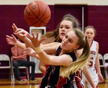 Wolverine Zoe Waltz and a Vinalhaven player scramble for a rebound Saturday. PHIL DI VECE/Wiscasset Newspaper