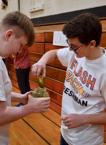 Johnny Spies, right, at the start of the pickle spitting contest. Kyle Ricker is holding the jar. PHIL DI VECE/Wiscasset Newspaper