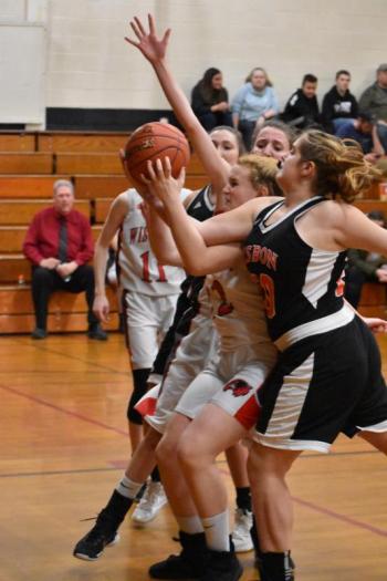 Madison Carrier comes down with a rebound in Saturday’s game with Lisbon. PHIL DI VECE/Wiscasset Newspaper