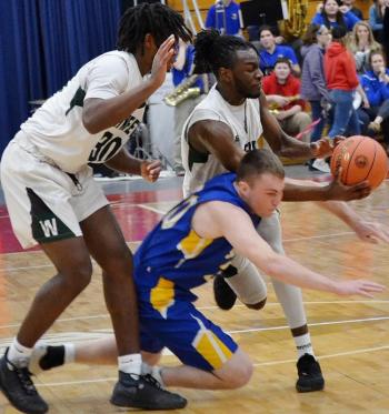 Boothbay’s Nicholas Morley scrambles for a loose ball Feb. 20 in the Seahawks’ 53-41 loss to Waynflete in the tournament. KEVIN BURNHAM/Boothbay Register