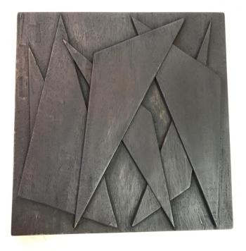 “Shards” - one in a series of seven mahogany, carved relief wall sculptures, 11” x 11” x 1” in the sunlight, by Eben Blaney. Eben Blaney.