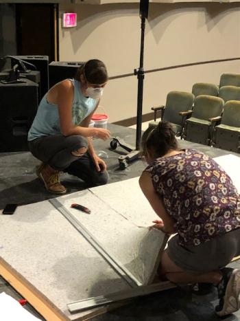 The family team of Cat and Brynna Skov cutting acoustic panels. Courtesy of Waldo Theater