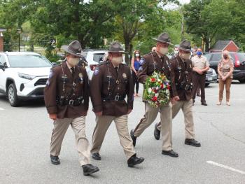 Lincoln County Sheriff Department’s honor guard presents a wreath Aug. 4 at a new courthouse monument honoring two law enforcement officers who lost their lives in service. BILL PEARSON/Boothbay Register