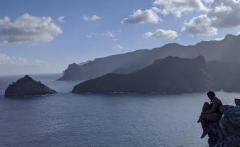 Solo sailor Holly Martin enjoys the view overlooking the rugged coastline of Nuku Hiva island in the Marquesas. Courtesy of Holly Martin