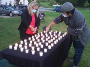 Addiction Outreach Specialist Holly Stover, left, and Harbor Peer & Wellness Center life coach Dylan Bredeau light candles Aug. 31 memorializing the 132 Mainers who died since June from drug overdoses. BILL PEARSON/Boothbay Register