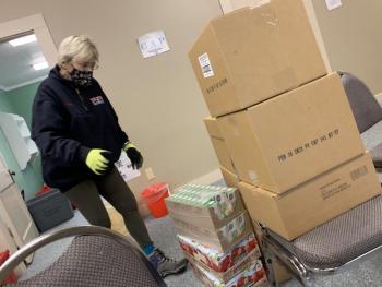 First Congregational member Susan Kubler helps move FOS supplies into an upstairs room of the church. SUSAN JOHNS/Wiscasset Newspaper