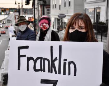 Kelli Whitlock Burton of Waldoboro holds a sign representing Franklin County, which has had seven COVID-19 deaths. Behind her are Tom Eichler and Wendy Ross of Wiscasset. PHIL DI VECE/Wiscasset Newspaper
