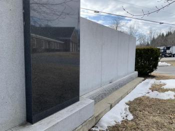 Snow recedes and the center of the veterans’ wall reflects Wiscasset’s municipal building March 9. SUSAN JOHNS/Wiscasset Newspaper