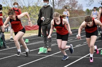 Running the 100-meter dash are, from left, Gwen Webber, Emily Gilliam and Reese Hesseltine. Hesseltine won the event. Webber was second, Gilliam third. PHIL DI VECE/Wiscasset Newspaper