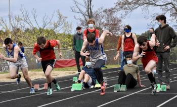 Austin Trask, second from left, and Bryan Gagnon, far right, run the 100-meter dash. Trask finished first, Gagnon third. PHIL DI VECE/Wiscasset Newspaper