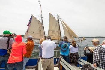 Passengers on a past Windjammer Days Photography cruise capture a moment during the parade of sails. Mike Leonard photo