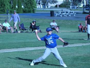Midcoast pitcher Leslie White Jr. throws to first base June 16 during a District 4 Cal Ripken Baseball Tournament. BILL PEARSON/Boothbay Register