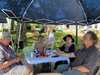 From left, John Apczynski, daughter-in-law Sabrina, wife Elaine and son John Jr. eat in the shade of a tent. SUSAN JOHNS/Wiscasset Newspaper