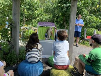 Puppet show under the grape arbor, with the story, "The Blue Jay and the Owl," Carried out by volunteer youth education steward Zoe Curtis and Youth Programs Educator Bridget VerVaet. LILLY CURTIS/Boothbay Register