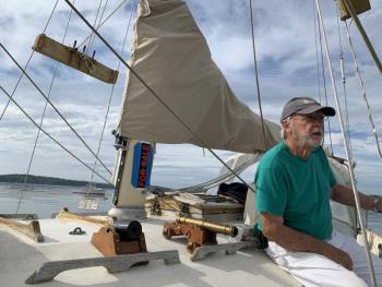 Boothbay’s Alan Boyes, on his and wife Judy’s Pagan Moon, waits to head out to give When and If a cannon salute. SUSAN JOHNS/Wiscasset Newspaper