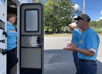 From left, volunteers Jane Diamond, Dennis Ela and Ron Eby stand by at the Wiscasset stop. SUSAN JOHNS/Wiscasset Newspaper