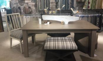 Dining room table with a fun Jeff Barrett sculpture. LISA KRISTOFF/Boothbay Register COVE by Knickerbocker Group
