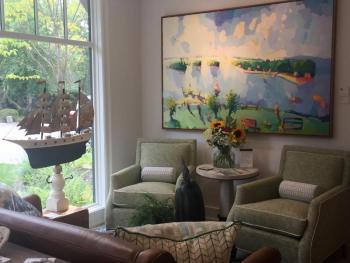 This living room features a color palette drawn from this colorful Henry Issacs painting. LISA KRISTOFF/Boothbay Register COVE by Knickerbocker Group