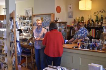 Erica Soule, left, owner of Rock Paper Scissors waits on a customer. PHIL DI VECE/Wiscasset Newspaper