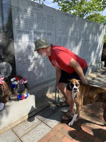 Wiscasset’s Jim George, with his boxer Callie, views the veterans wall. SUSAN JOHNS/Wiscasset Newspaper