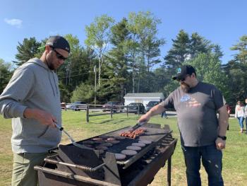 Matt Petrie, left, is on burgers and Joseph Bluteau, hot dogs, May 20. SUSAN JOHNS/Wiscasset Newspaper