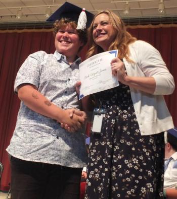 Sixth grade graduate Rick Wyatt Jones beams as Principal Dr. Christina Boursaw presents him with his diploma. BILL PEARSON/Boothbay Register
