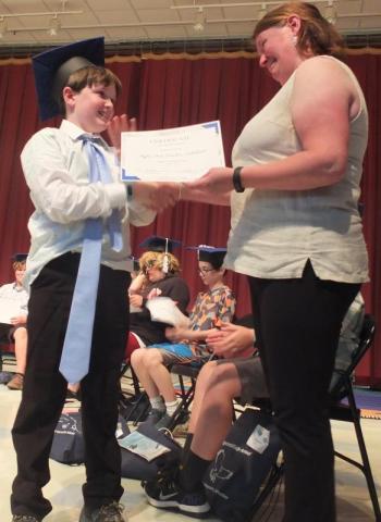 Edgecomb School Committee’s Heather Sinclair claims her son had a regular size tie when he left for school on June 16, but she is all smiles as she awards Myles Ian Sinclair-Whitfield his sixth grade diploma. BILL PEARSON/Boothbay Register