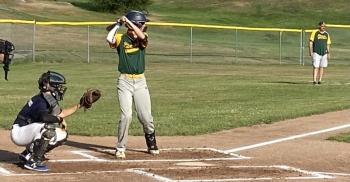 Aidric Canada of Boothbay at the plate against Bath while Adam Harkins, the Lincoln coach, observes the defensive alignment. Lincoln edged Bath 5-4 on July 14. Shanon Cotta photo
