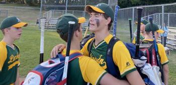 The Lincoln Babe Ruth baseball team congratulates Finn Harkins of Boothbay after a strong pitching performance. Henry Putnam, Liam Thomas Jacobs, Finn Harkins, Owen Cotta and Patrick Sanborn offer support to the team. Lincoln beat Bath 5-4. Shanon Cotta photo