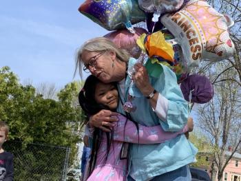 Wiscasset Elementary School second grader Giemella Absalud and first grade teacher Trae Stover hug at a May 13 celebration, the morning after Stover was named Lincoln County teacher of the year. SUSAN JOHNS/Wiscasset Newspaper
