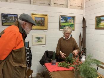 Mare LeMay explains the process of building a tree to Michael Olszewski of Wiscasset. EDNA MILLER/Wiscasset Newspaper