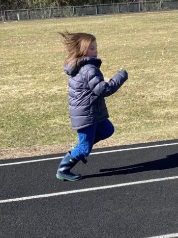 Liam Aarons, 7, from Woolwich runs on the track to stay warm while waiting for the hunt. EDNA MILLER/Wiscasset Newspaper