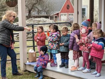 Sheepscot Valley Children’s House preschool class from Wiscasset sings and signs a friendship song to the their adopted” alpaca Theodora on April 11 in Southport. CANDI JONETH/Boothbay Register