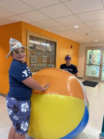 Byran, left, and Hannah Hills with a giant beach ball at the Annual Fund kick-off event at the Y pool. Allyson Goodwin photo