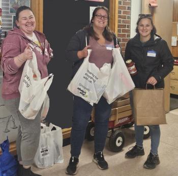 Partners in Education volunteers Beth Bluteau, not pictured, and, from left, Annaliese Hart Inchaurregui, Lucy Oyster-Ackerman and Marissa DeCosta bagged donations. Beth Bluteau photo