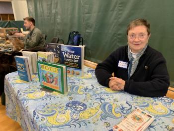 Volunteer Blanche Johnson shows some of Wiscasset Public Library’s environmentally themed offerings. SUSAN JOHNS/Wiscasset Newspaper