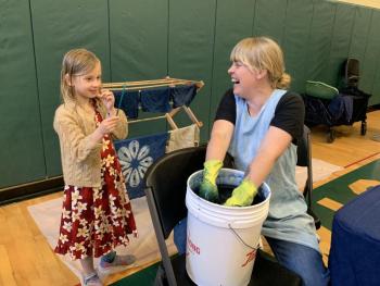 Indigo Sanders-Stoyle, 7, of Wiscasset watches artist Emily Bell-Hoerth dip and dye in indigo at Wiscasset’s Earth Day celebration at Wiscasset Community Center April 27. SUSAN JOHNS/Wiscasset Newspaper
