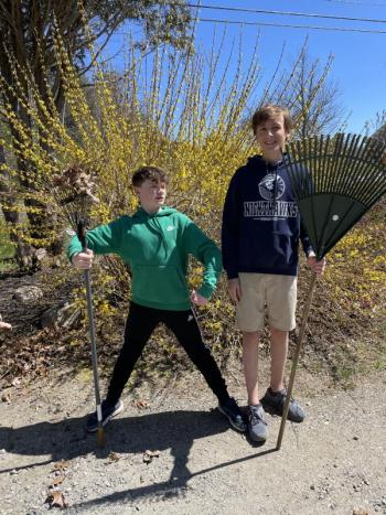 Kelly Manahan and Carter Wilson rake leaves near the front of the school. Courtesy of CTL