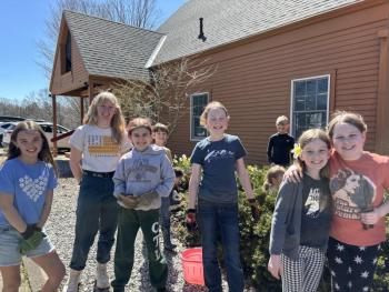 CTL students from kindergarten through fifth grade plant flowers in garden beds at the front of the school. Courtesy of CTL