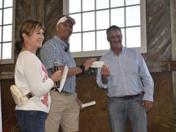 Boothbay Harbor Chamber board member Julie Roberts presents a check for the Fishermen’s Memorial Fund. Accepting on behalf of FMF is Corey Pottle. LISA KRISTOFF/Boothbay Register