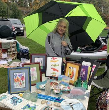 Volunteer Rosemarie Giordano displayed a beautiful collection of art during the yard sale. BILL PEARSON/Boothbay Register Rosemarie