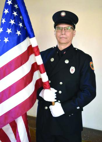 Woolwich first responder Frank Petrulli posts the colors. PHIL DI VECE/Wiscasset Newspaper