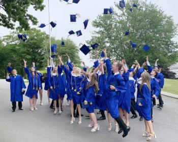 The BRHS Class of 2024 tosses their caps after the graduation ceremony. KEVIN BURNHAM/Boothbay Register